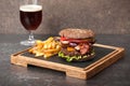 Burger, french fries and dark beer