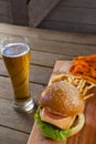 Burger and french fries with glass of beer Royalty Free Stock Photo