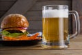 Burger and french fries in plate with glass of beer Royalty Free Stock Photo