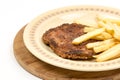 Burger with french fries served on the plate. Minced meat hamburger with potatoes isolated over white background Royalty Free Stock Photo