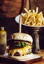 burger with french fries on a wooden background. toning. selective focus