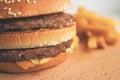 Burger and French fries on a wooden board