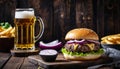 A burger and fries with a glass of beer Royalty Free Stock Photo