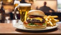 A burger and fries on a plate with a glass of beer Royalty Free Stock Photo