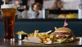 A burger and fries on a table with a glass of beer Royalty Free Stock Photo