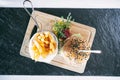 Burger with fries and vegetables on a board. Dinner main dish on a wooden table. Traditional polish cuisine