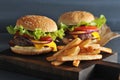 Burger with fries on wooden rustic Board