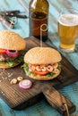 Burger with grilled prawns and glass of light beer Royalty Free Stock Photo