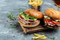 Burger with ham, cheese, bacon, salad and vegetables. Big burger, american fast food. banner, menu, recipe place for text Royalty Free Stock Photo