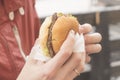 Burger in the hand. Royalty Free Stock Photo
