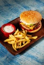 Burger. Juicy pork cutlet, cheddar cheese, crispy pickled onions, lettuce wrapped in a bun under two sauces. Served with