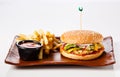 Burger. Juicy pork cutlet, cheddar cheese, crispy pickled onions, lettuce wrapped in a bun under two sauces. Served with