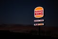 Burger King Drive Thru neon light post during the twilight hour in Braga.