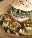 Burger with Onion Bun and Baked Zuchinni Royalty Free Stock Photo