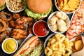 Burger, onion rings and other fast food as background, top view Royalty Free Stock Photo