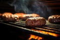 burger patties under the focused beam of a grill light