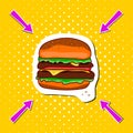 Classic colored hamburger on a yellow pop background whith arrows.