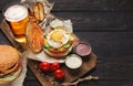 Burger and potatoes served with beer at restaurant Royalty Free Stock Photo