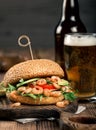 Burger with prawns grilling and a glass lager beer