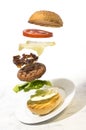 Burger preparation sliced ingredients levitating on white background