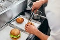 Burger Restaurant. Closeup Chef Cooking Burgers In Kitchen. Royalty Free Stock Photo