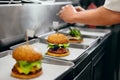 Burger Restaurant. Closeup Chef Cooking Burgers In Kitchen. Royalty Free Stock Photo