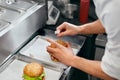 Burger Restaurant. Closeup Chef Cooking Burgers In Kitchen. Royalty Free Stock Photo