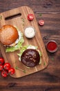 Burger with sauce on wooden desk top Royalty Free Stock Photo