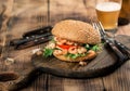 Burger with seafood on the old board with lager Royalty Free Stock Photo