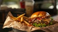 Burger stacked high with a thick, juicy patty, melted cheese, crispy bacon, fresh lettuce, tomato, and red onion on a toasted bun.