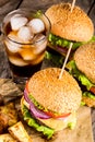 Burgers with beef and fried potatoes and glass of cold beer Royalty Free Stock Photo