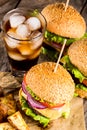 Burgers with beef and fried potatoes and glass of cold beer