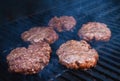 Burgers cooking on barbecue Royalty Free Stock Photo