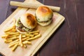 Ã Â¸ÂºBurgers and fries on a wooden