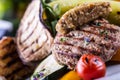 Burgers. Grill burgers. Minced burgers. Roasted burgers with grilled vegetable and herb decoration. Minced meat grilled in a hotel