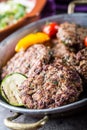 Burgers. Grill burgers. Minced burgers. Roasted burgers with grilled vegetable and herb decoration. Minced meat grilled in a hotel Royalty Free Stock Photo