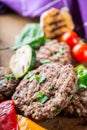 Burgers. Grill burgers. Minced burgers. Roasted burgers with grilled vegetable and herb decoration. Minced meat grilled in a hotel Royalty Free Stock Photo