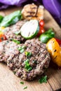 Burgers. Grill burgers. Minced burgers. Roasted burgers with grilled vegetable and herb decoration. Minced meat grilled in a hotel Royalty Free Stock Photo