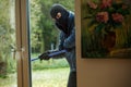 Burglar behind window Royalty Free Stock Photo