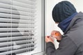 Burglar breaking and entering into home Royalty Free Stock Photo