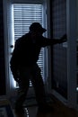 Burglar Breaking In To Home At Night Through Back Royalty Free Stock Photo