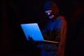 Burglar with computer - isolated on black Royalty Free Stock Photo