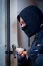 Burglar with crowbar to break door to enter the house Royalty Free Stock Photo