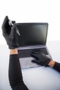 Burglar hacking laptop and mobile phone Royalty Free Stock Photo