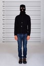 Burglar Standing Against Police Lineup Royalty Free Stock Photo