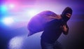 Burglar or thief is running away. Police car is chasing him at night. Royalty Free Stock Photo