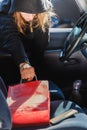 Burglar thief stealing smartphone and bag from car Royalty Free Stock Photo