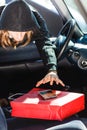 Burglar thief stealing smartphone and bag from car Royalty Free Stock Photo