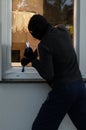 Burglar trying to open a window Royalty Free Stock Photo