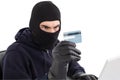 Burglar using credit card and laptop